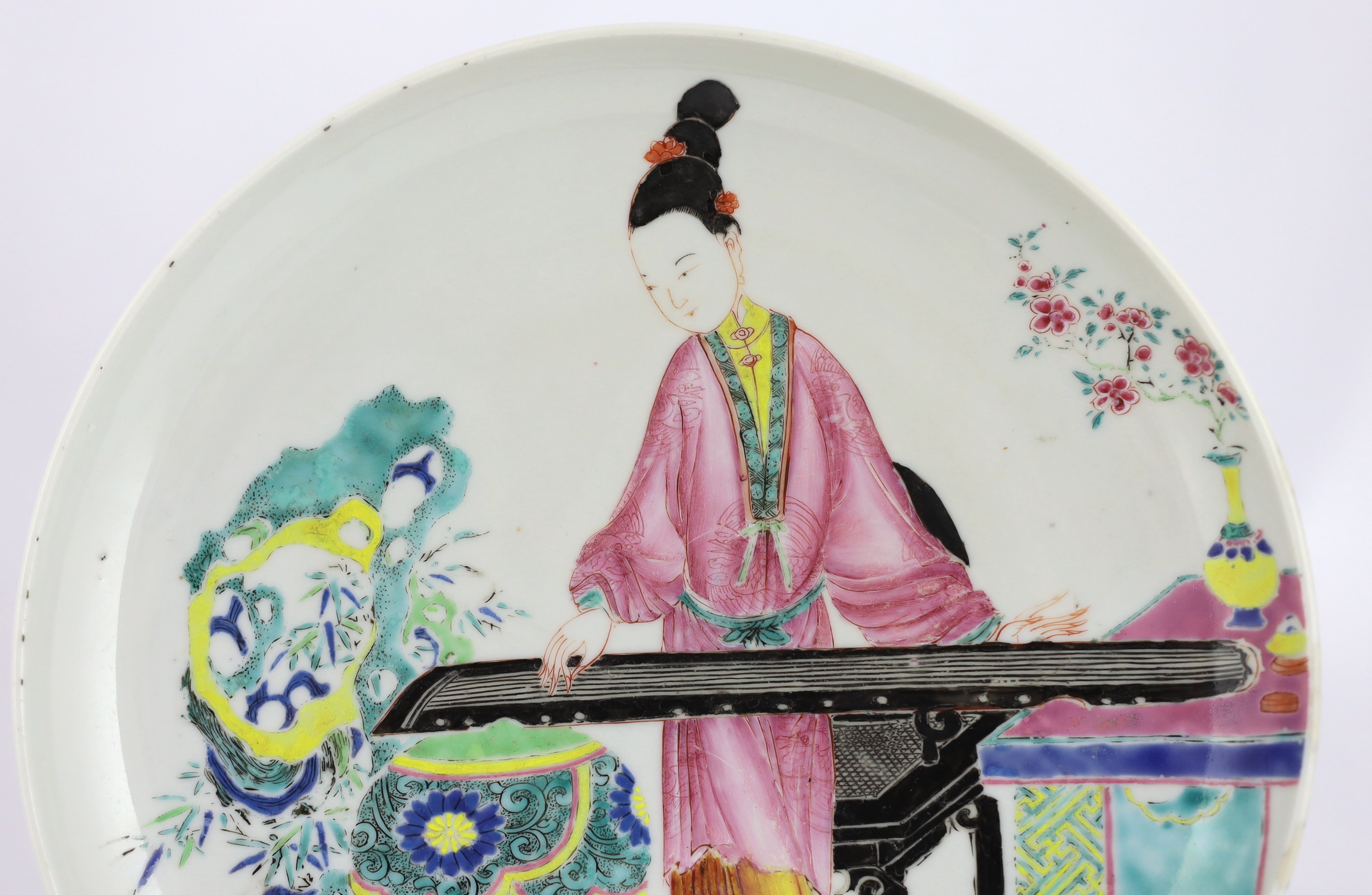 A Chinese famille rose saucer dish, Yongzheng period, repainting to enamel colours, Please note this lot attracts an additional import tax of 5% on the hammer price